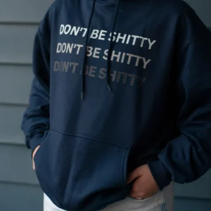 dbs-ombre-hoodie-navy-worn-front Woman wearing the navy DON'T BE SHITTY ombre hoodie