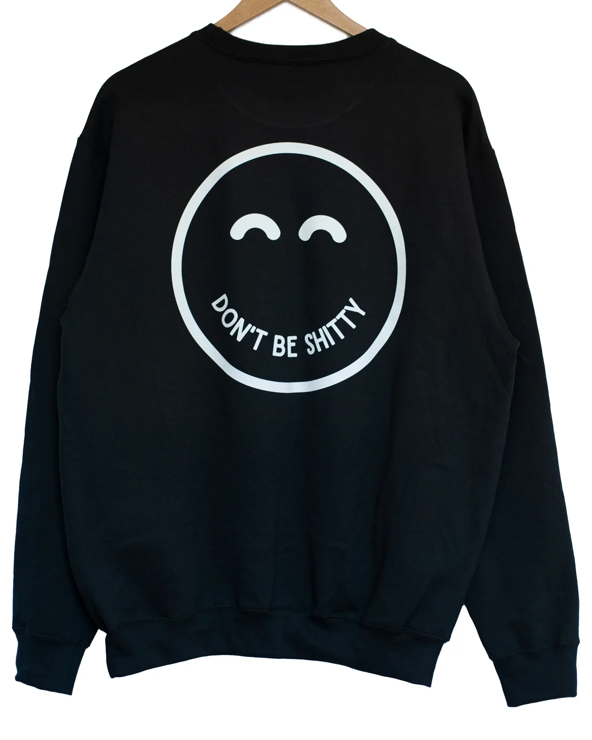Front of the black DON'T BE SHITTY smiley crewneck with the small chest logo