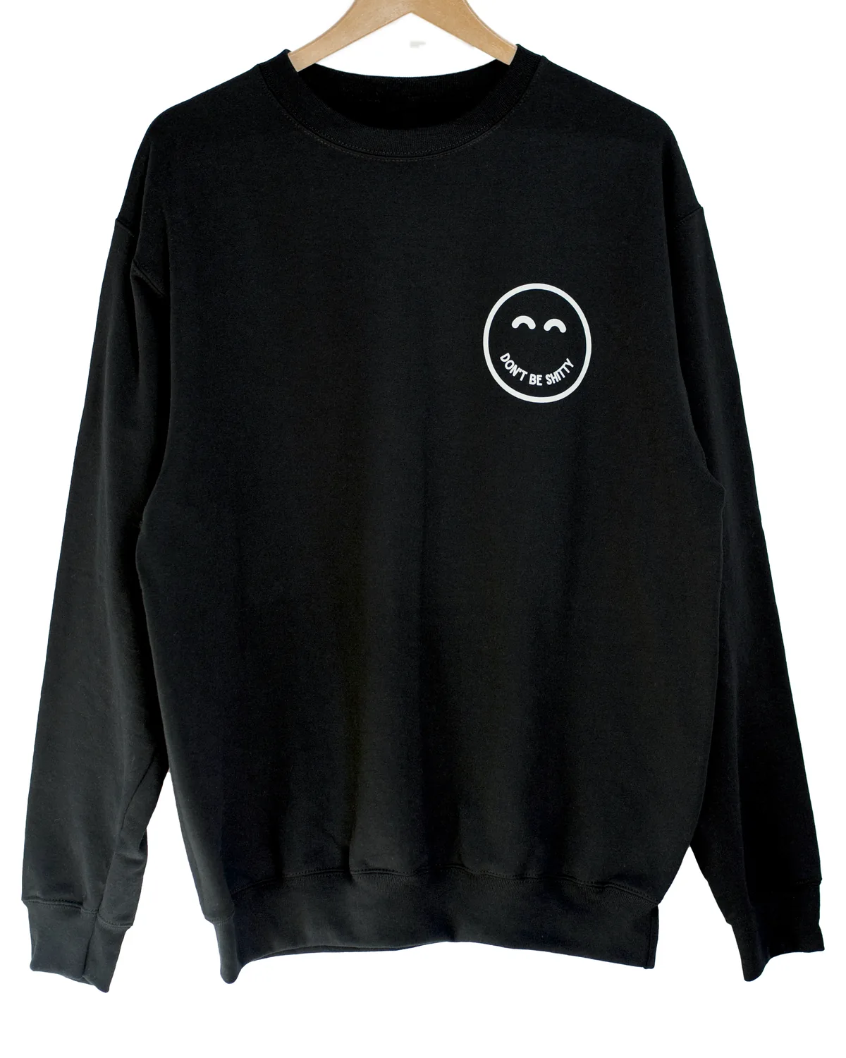 Black DON'T BE SHITTY smiley crewneck sweatshirt on a hanger